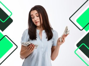 pretty-young-business-girl-holding-money-thoughtfully-looking-at-them-over-white-wall