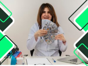 cheerful-female-doctor-wearing-medium-robe-and-stethoscope-sitting-at-table-with-medical-tools-clipboard-and-laptop-holding-money-isolated
